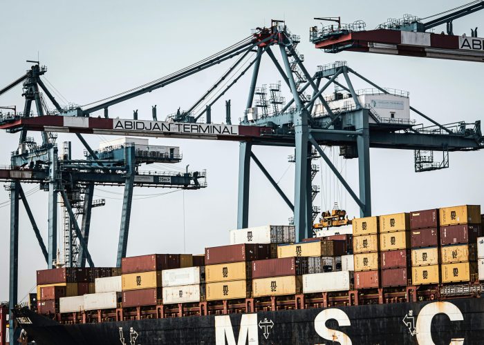 A view of large cranes and cargo containers at the busy Abidjan Terminal port.